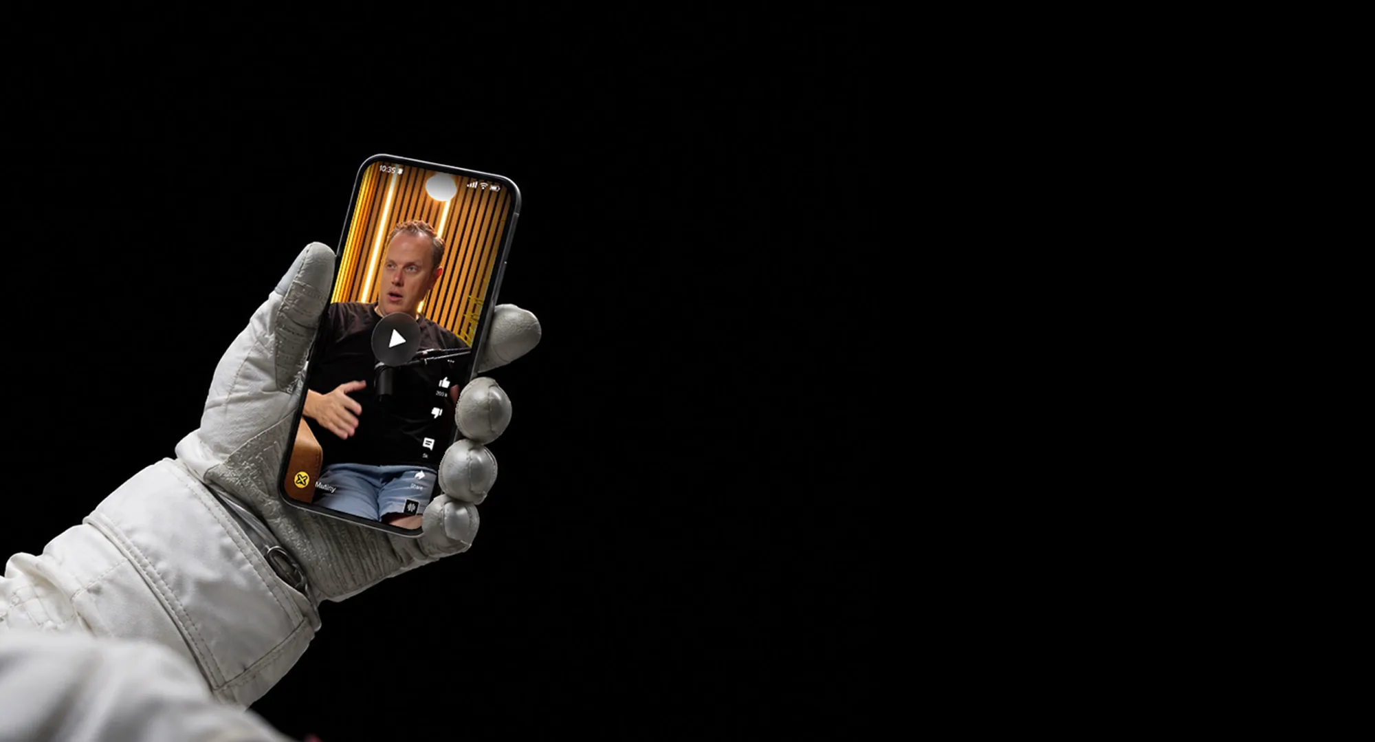 Astronaut glove holding a phone playing a Mutiny video